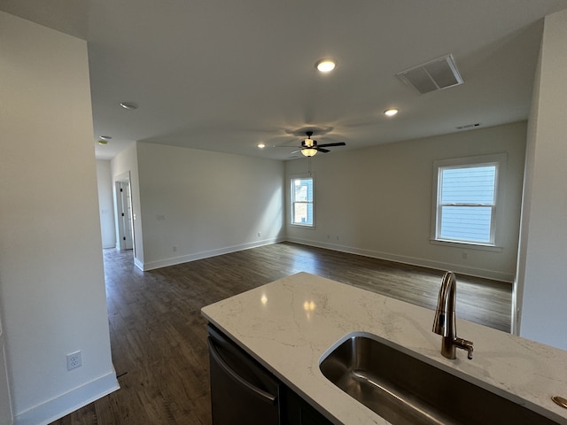 kitchen with dishwasher, sink, dark hardwood / wood-style flooring, ceiling fan, and light stone countertops