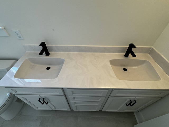 bathroom with vanity, tile patterned floors, and toilet