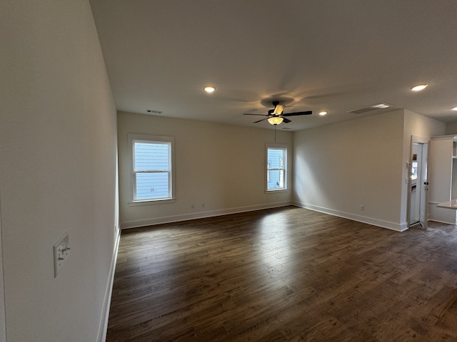 unfurnished room with dark wood-type flooring and ceiling fan