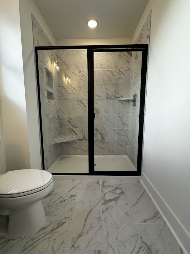 bathroom with an enclosed shower and toilet