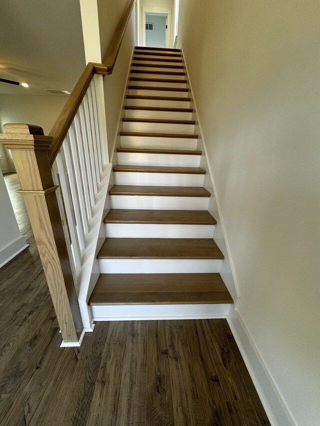 stairway with hardwood / wood-style floors