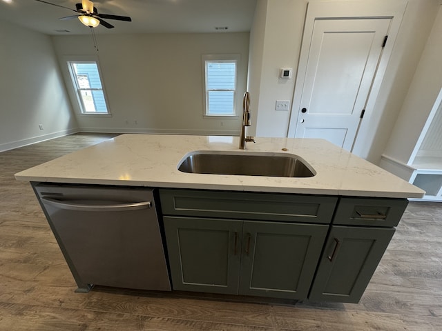 kitchen featuring sink, a center island with sink, dark hardwood / wood-style flooring, dishwasher, and light stone countertops