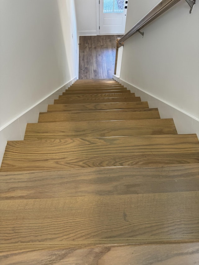 stairs with hardwood / wood-style flooring