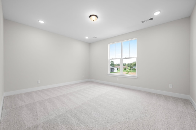 unfurnished room with recessed lighting, visible vents, baseboards, and light colored carpet