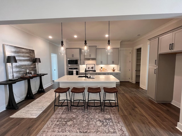 kitchen with backsplash, appliances with stainless steel finishes, gray cabinets, and light countertops