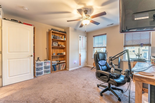 home office with ceiling fan and carpet floors