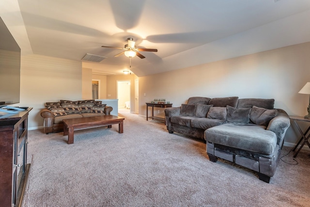 carpeted living room with ceiling fan