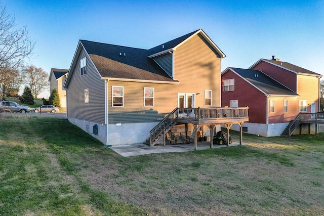 rear view of property featuring a deck and a yard