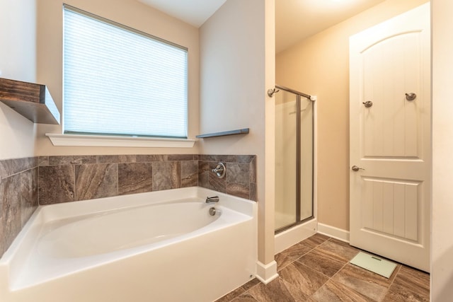 bathroom featuring separate shower and tub