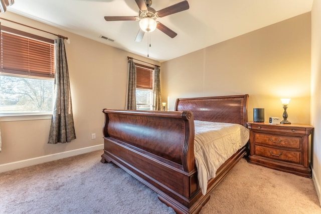 bedroom with ceiling fan and light colored carpet