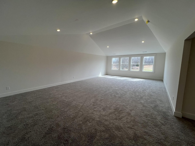 carpeted spare room with vaulted ceiling, recessed lighting, and baseboards