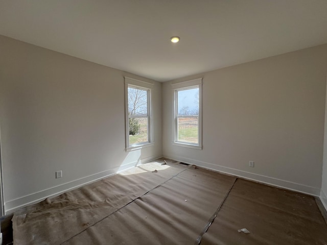 spare room with baseboards