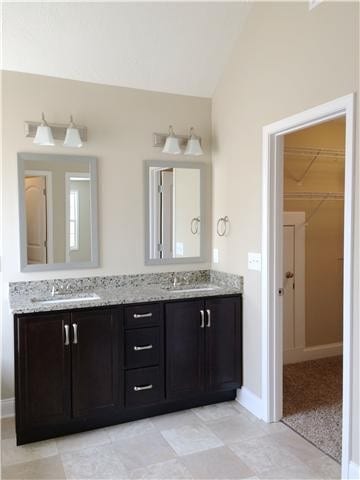 bathroom with vanity and vaulted ceiling