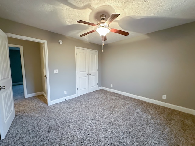 unfurnished bedroom with carpet, a textured ceiling, a closet, and ceiling fan