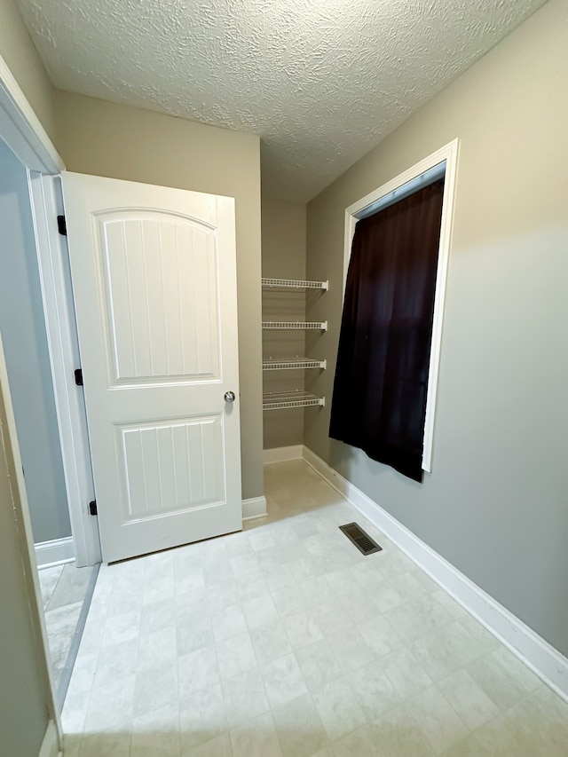 bathroom featuring a textured ceiling