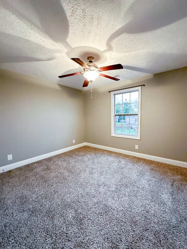 carpeted empty room featuring a textured ceiling and ceiling fan