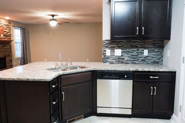 kitchen featuring ceiling fan, sink, stainless steel dishwasher, backsplash, and light tile patterned flooring