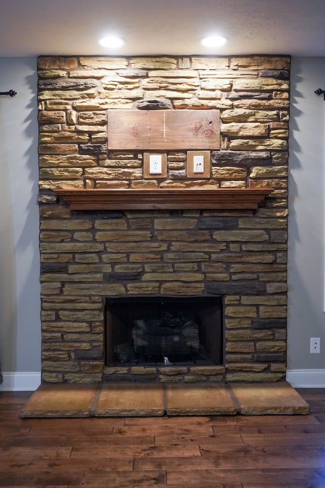 room details with a fireplace and wood-type flooring