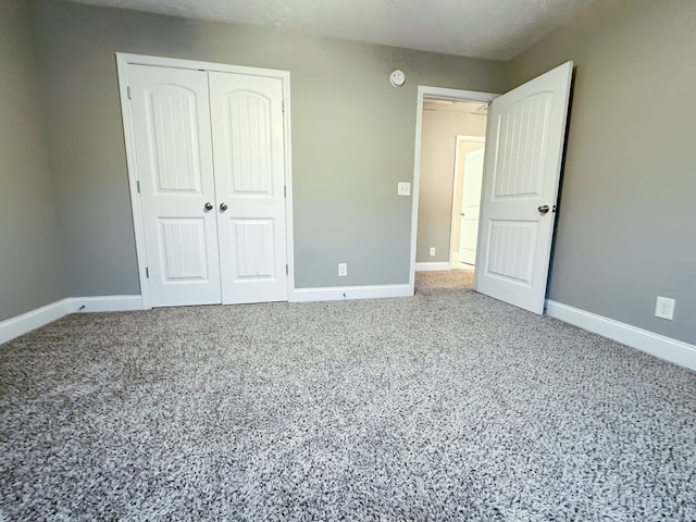 unfurnished bedroom featuring carpet flooring and a closet