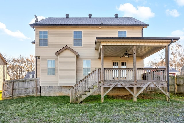 back of property with a yard, a deck, and ceiling fan