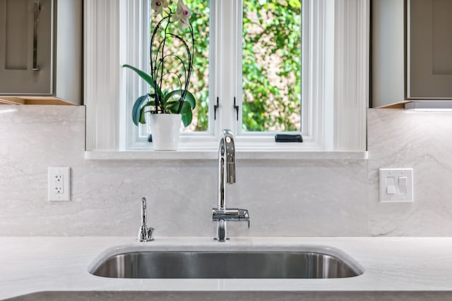 details featuring sink and tasteful backsplash