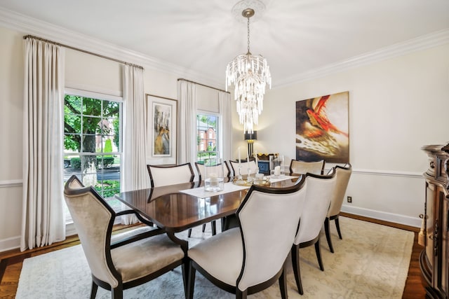 dining room featuring a wealth of natural light, crown molding, hardwood / wood-style floors, and a notable chandelier