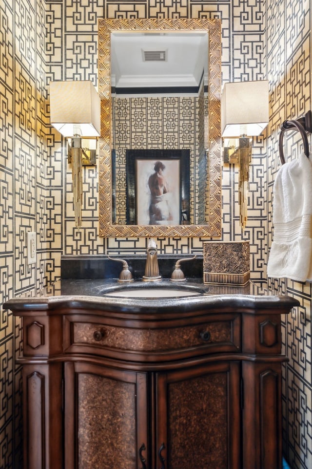 bathroom featuring crown molding and vanity