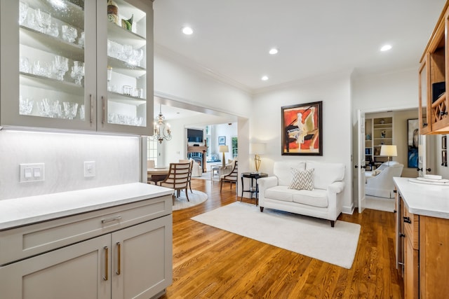 living room with dark hardwood / wood-style flooring and ornamental molding