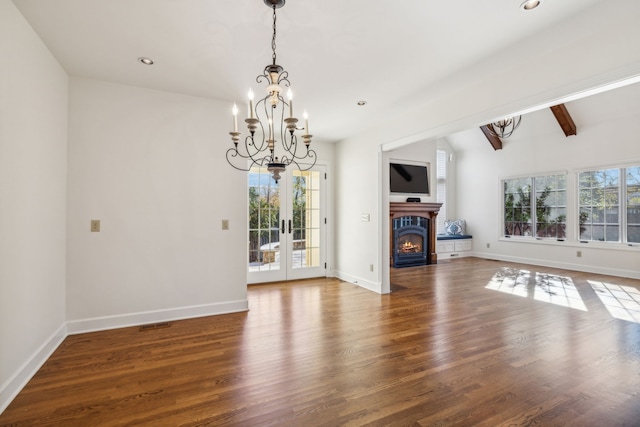 unfurnished living room with french doors, vaulted ceiling with beams, plenty of natural light, and dark wood-type flooring