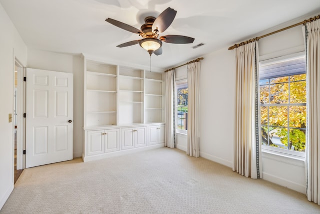 unfurnished room featuring ceiling fan and light carpet