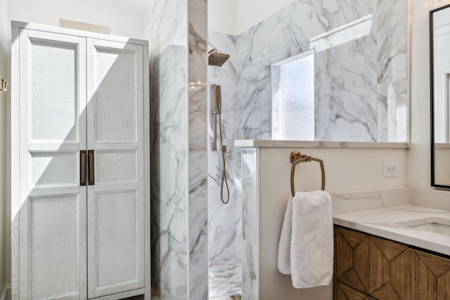 bathroom with vanity and tiled shower