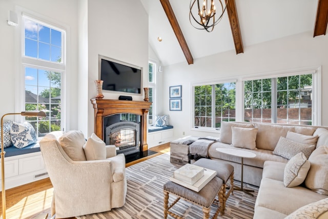 living room with light wood-type flooring, high vaulted ceiling, and a wealth of natural light