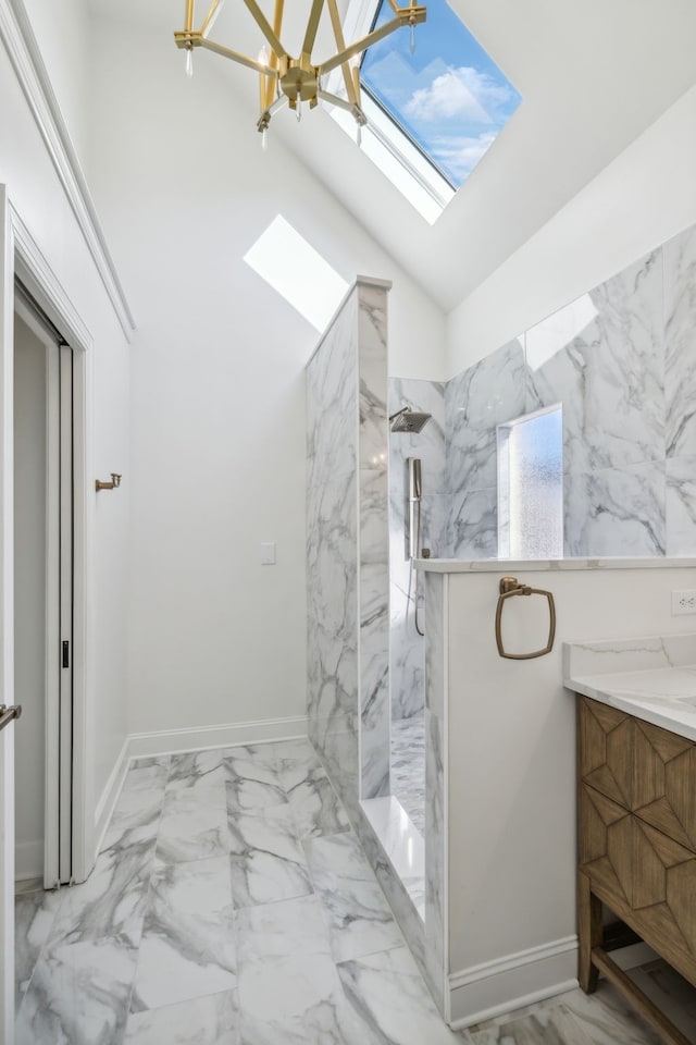 bathroom with a tile shower, a skylight, high vaulted ceiling, a chandelier, and vanity