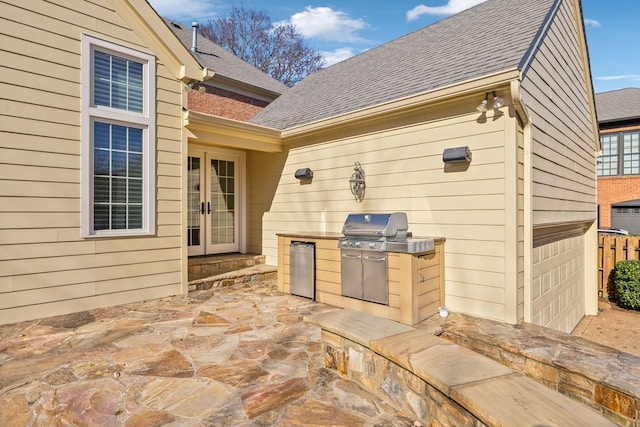 view of patio with area for grilling and french doors