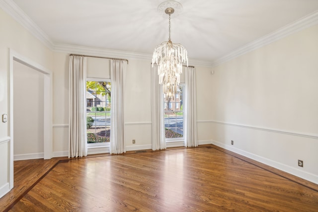 unfurnished room with wood-type flooring, ornamental molding, and a notable chandelier