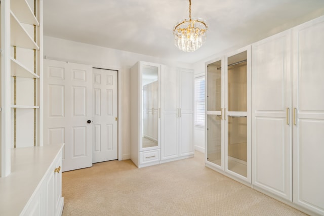 unfurnished bedroom with two closets, light colored carpet, and a chandelier