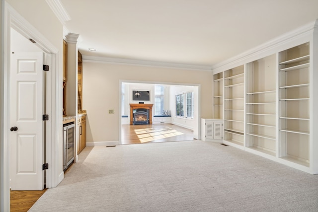 corridor with light carpet, wine cooler, and ornamental molding