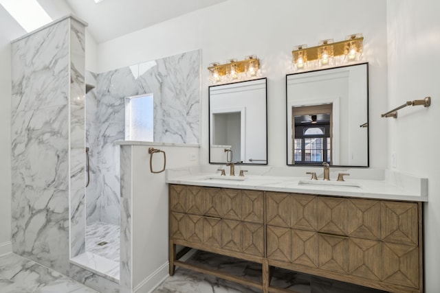 bathroom with a tile shower, vanity, and plenty of natural light