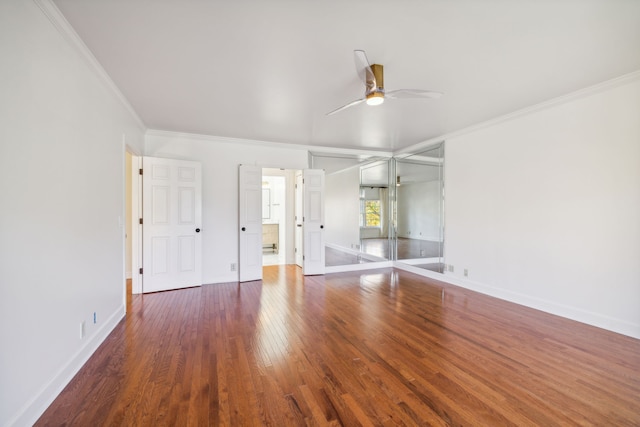 unfurnished bedroom with ceiling fan, dark wood-type flooring, and ornamental molding