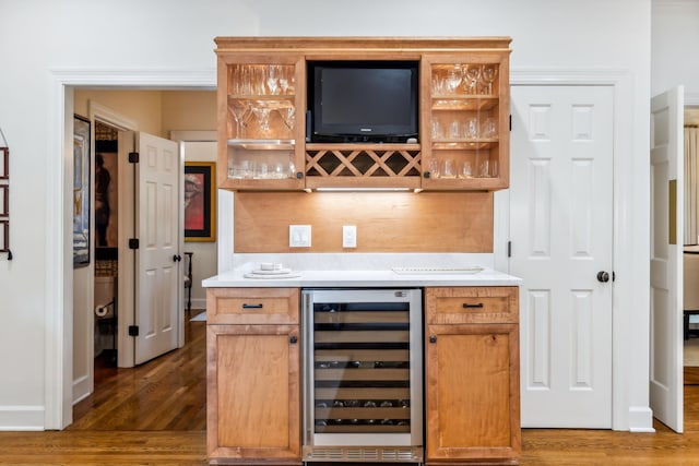 bar with dark hardwood / wood-style floors and wine cooler