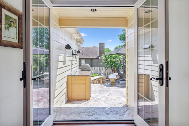 entryway featuring crown molding and french doors