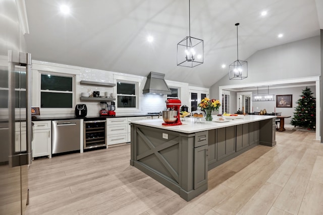 kitchen featuring gray cabinetry, white cabinetry, a large island, beverage cooler, and premium range hood