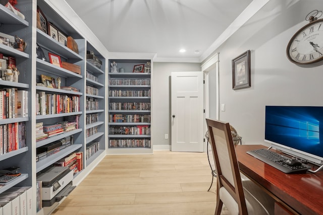 home office with light hardwood / wood-style flooring