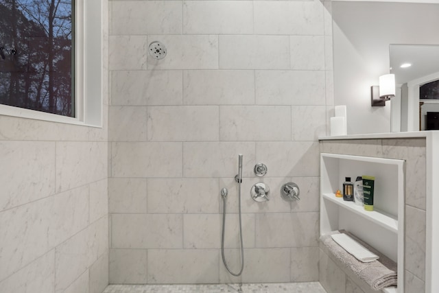 bathroom with a tile shower