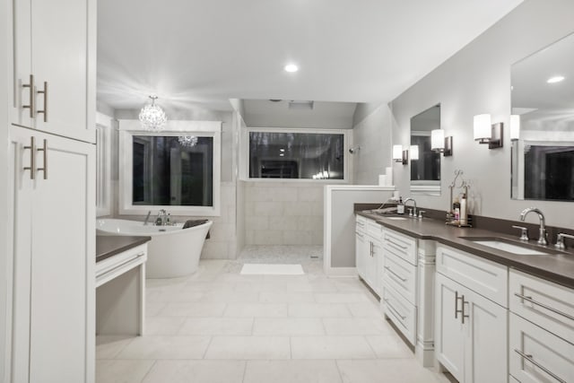 bathroom featuring vanity, tile patterned flooring, and plus walk in shower