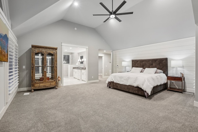 bedroom featuring light carpet, ensuite bath, ceiling fan, and lofted ceiling