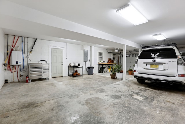 garage featuring electric panel and water heater