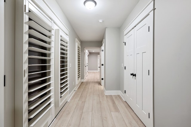 corridor with light hardwood / wood-style floors