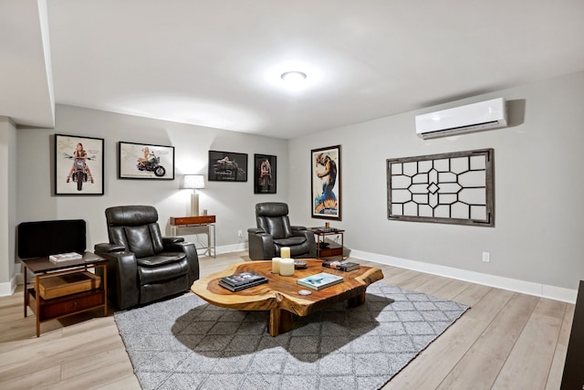 sitting room featuring light wood-type flooring and a wall unit AC