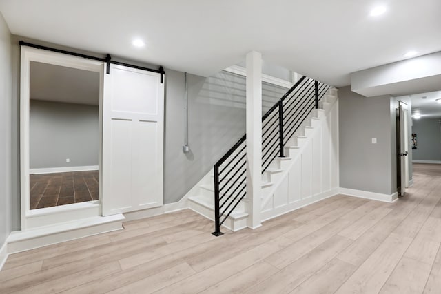 interior space featuring a barn door and hardwood / wood-style floors